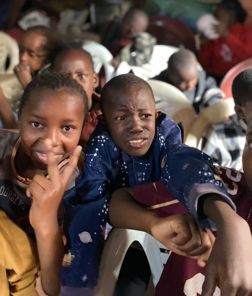 A child receiving school supplies